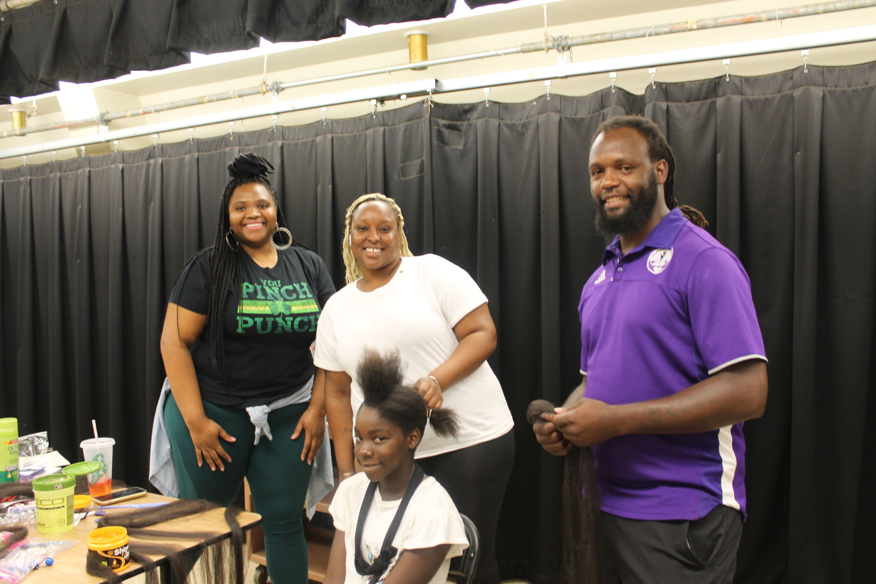 (L to R) Wahtinna Fowles and Miya Allen, and MCI’s Angel Johnson get Ashanti ready for 7th grade